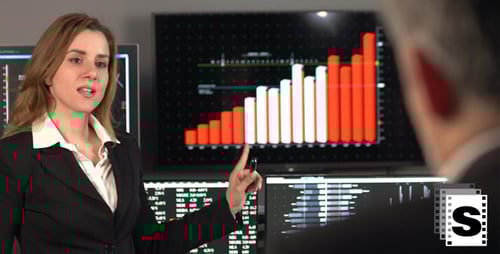 Businesswoman Presenting Financial Data in Modern Office