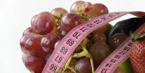 Fresh Fruits with Measuring Tape Promoting Healthy Eating
