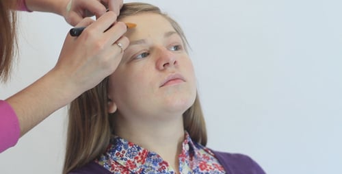 Woman Receives Makeup Application with Brush