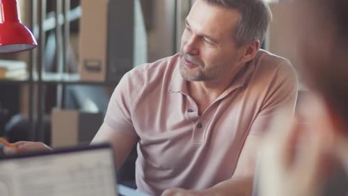Man Discussing Business Data with Colleague