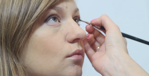 Woman Receiving Makeup Application With Brush
