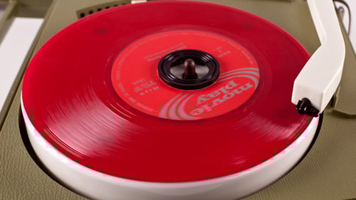 Red Vinyl Record Spinning on Vintage Turntable