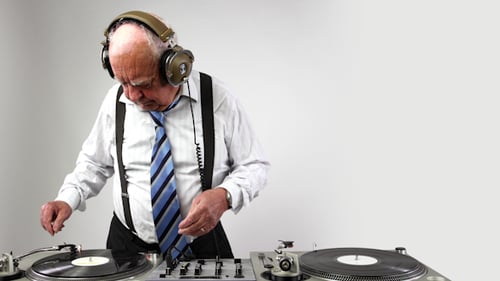 Senior Man with Headphones DJing with Records