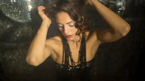 Glamorous Woman Dancing with Disco Balls