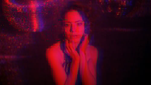 Glamorous Woman Dances Under Disco Ball Lights