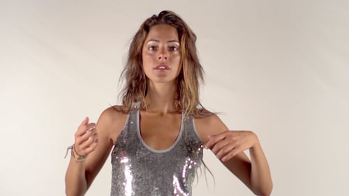 Attractive Woman Dances in Sparkling Silver Top