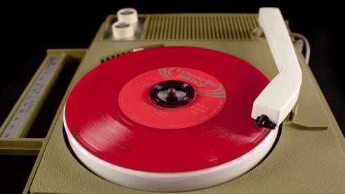 Red Record Spinning on Vintage Record Player