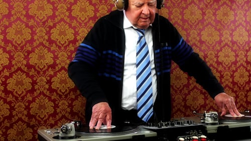 Senior Man Mixing Music on DJ Turntable