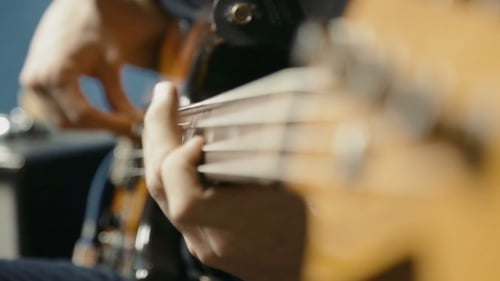 Musician Playing Bass Guitar in Studio Close Up