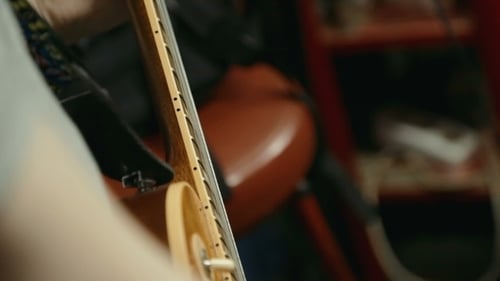 Close-up of Guitar Playing a Stringed Instrument