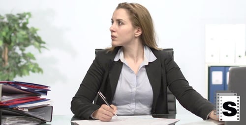 Businesswoman Working at Desk Gets Stressed