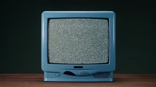 Blue Vintage Television with Static on Wooden Table