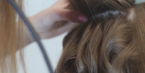 Hairdresser Makes Hairdress Using Curling Irons