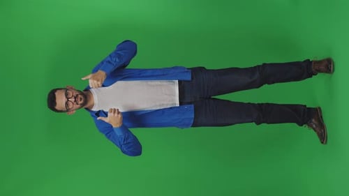 Enthusiastic Man Gives Thumbs Up in Front of Green Screen