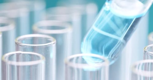 Placing Test Tube with Blue Liquid into Rack