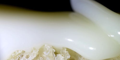 Creamy White Substance Being Poured on White Bread