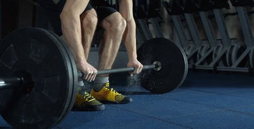 Man Deadlifting Barbell in Gym for Strength Training
