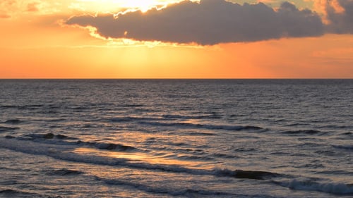 Golden Sunset Over Calm Ocean Waves