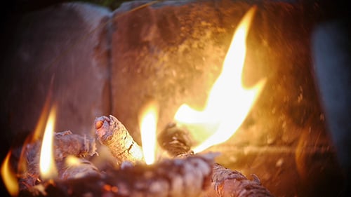 Roaring Campfire with Glowing Embers in Stone Pit