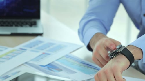 Close Up Of Businessman Points At His Watch