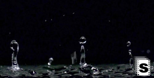 Water Droplets Splashing in Slow Motion on Dark Surface