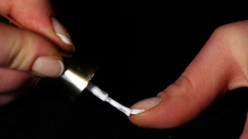 White Nail Polish Applied to Fingernail Close Up