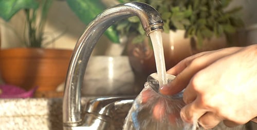 Hands Wash Spoon with Soap under Faucet