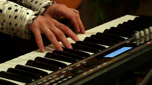 Hands Playing Keyboard Instrument in Close Up