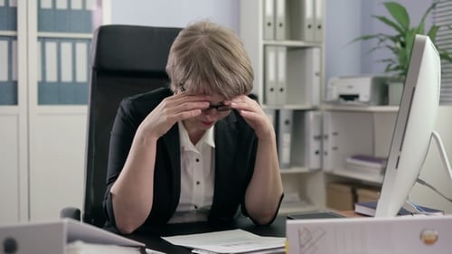 Businesswoman Reviews Paperwork and Gets Stressed