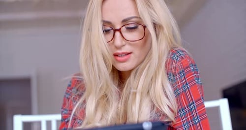 Blonde Woman Using Tablet Indoors