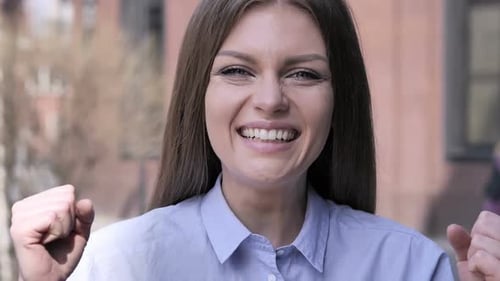Excited Woman Reacting to Success Standing Outside Office