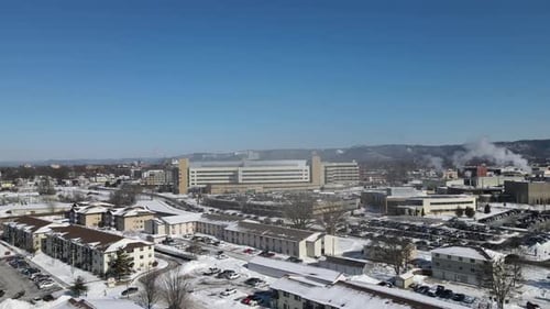 Aerial view on a cold, bright, blue day in winter. Residential neighborhood and business.