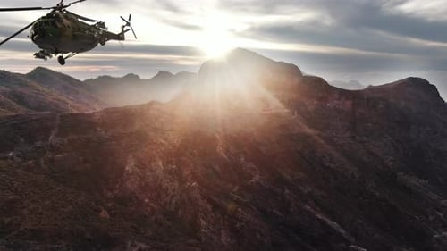 Helicopter Flying Over Mountains at Sunrise