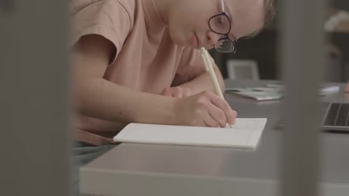 Girl Focused Writing Indoors at Home