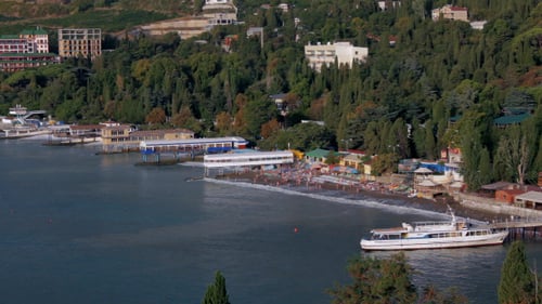Picturesque Beachside Scene with Boat and Distant People
