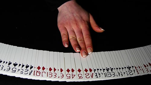 Hand Spreading Deck of Playing Cards in Fan