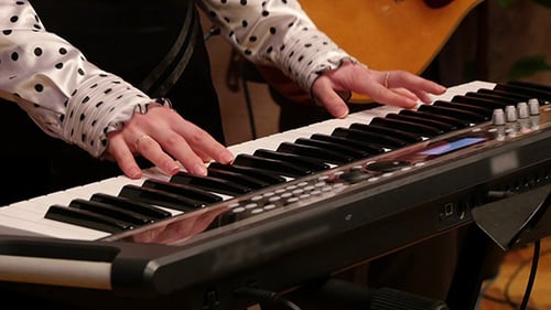 Close Up of Hands Playing Electronic Keyboard