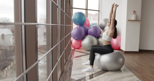 Woman in Sportswear Doing Exercise on a Fitness Ball