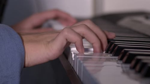 Hands Playing the Piano Keys