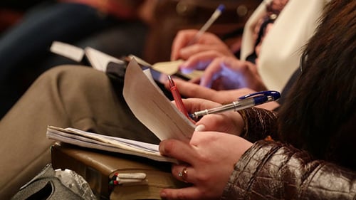 College Student Taking Notes While Studying