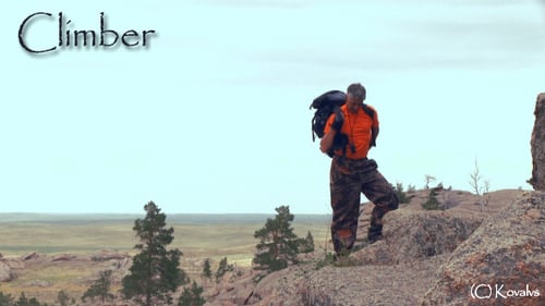 Man Prepares for Hiking Adventure in Rural Landscape