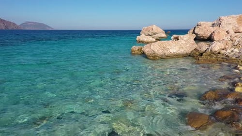 Crystal Clear Turquoise Sea Water Background and Rocky Coast