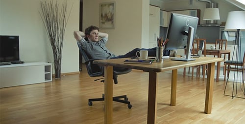 Young Man Relaxing at Desk in Modern Office