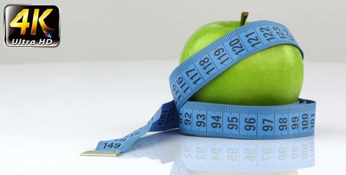 Green Apple Wrapped in a Measuring Tape