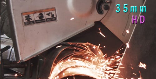 Chop Saw Cutting Metal Showers Sparks in Workshop