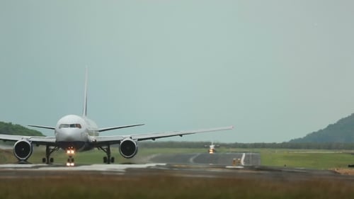 Airplane Landing on Runway During Daytime