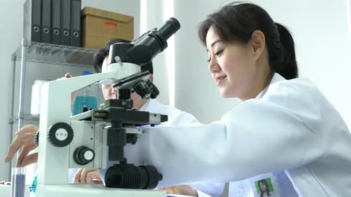 Scientist experimenting chemicals in science laboratory