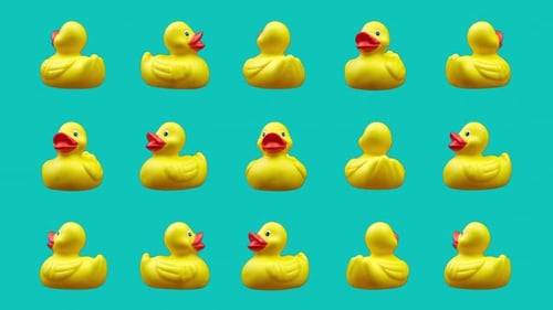 Rotating Yellow Rubber Ducks on Cyan Background Loop