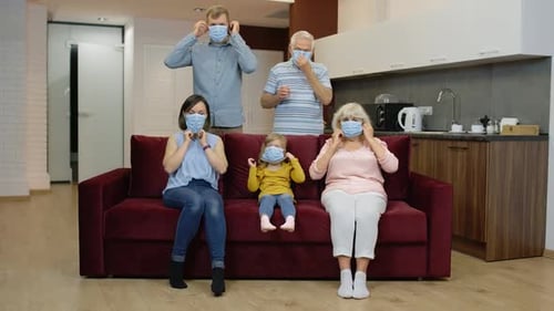 Family Wearing Protective Face Masks Indoors