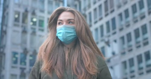 Portrait of Beautiful Caucasian Woman with Grey Eyes Wearing Protective Mask in City. Young Girl